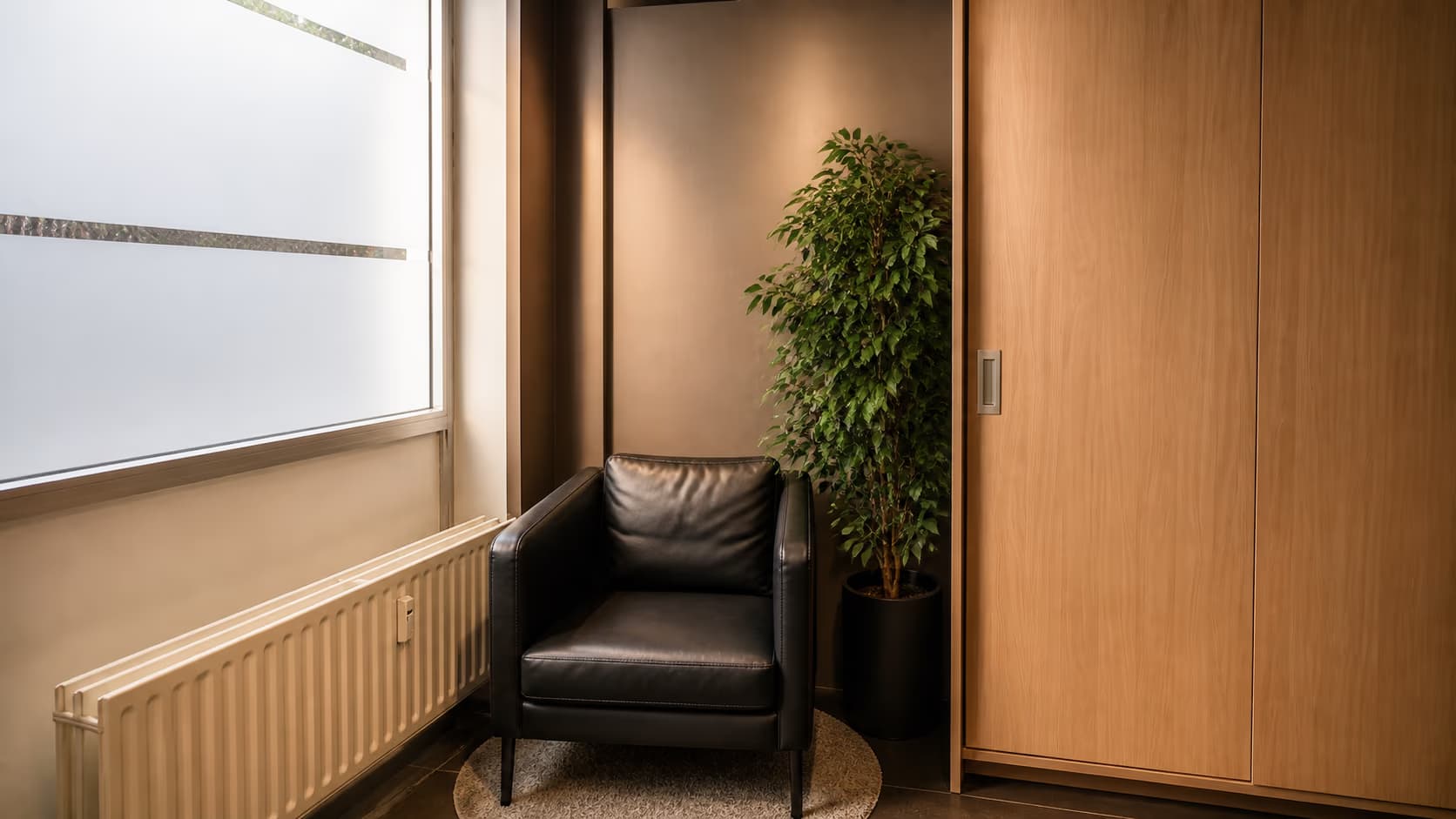 A quiet corner of the Finexpert office with an armchair and a plant