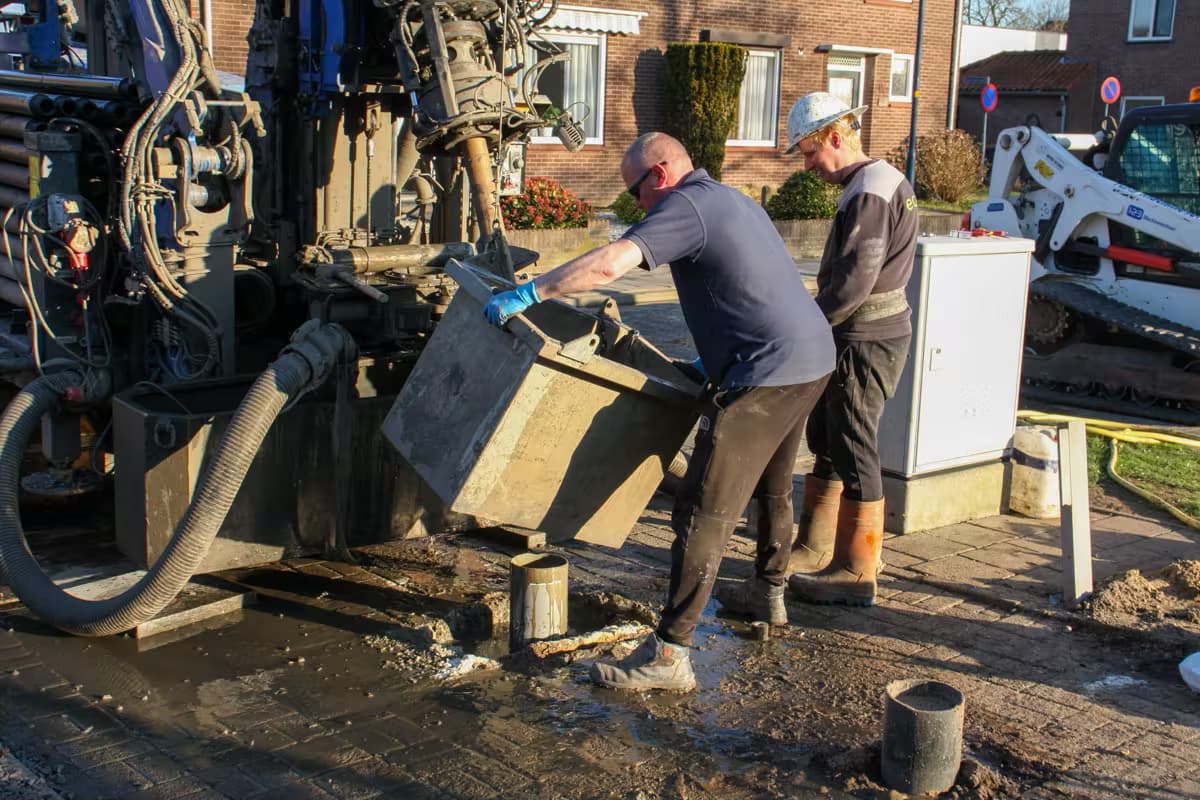 Contractors drilling on a site in a residential area