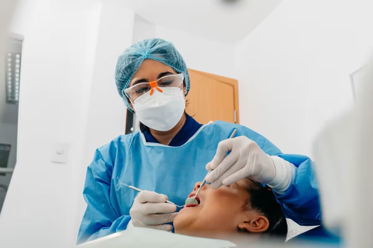 Dentist treating a patient at the practice