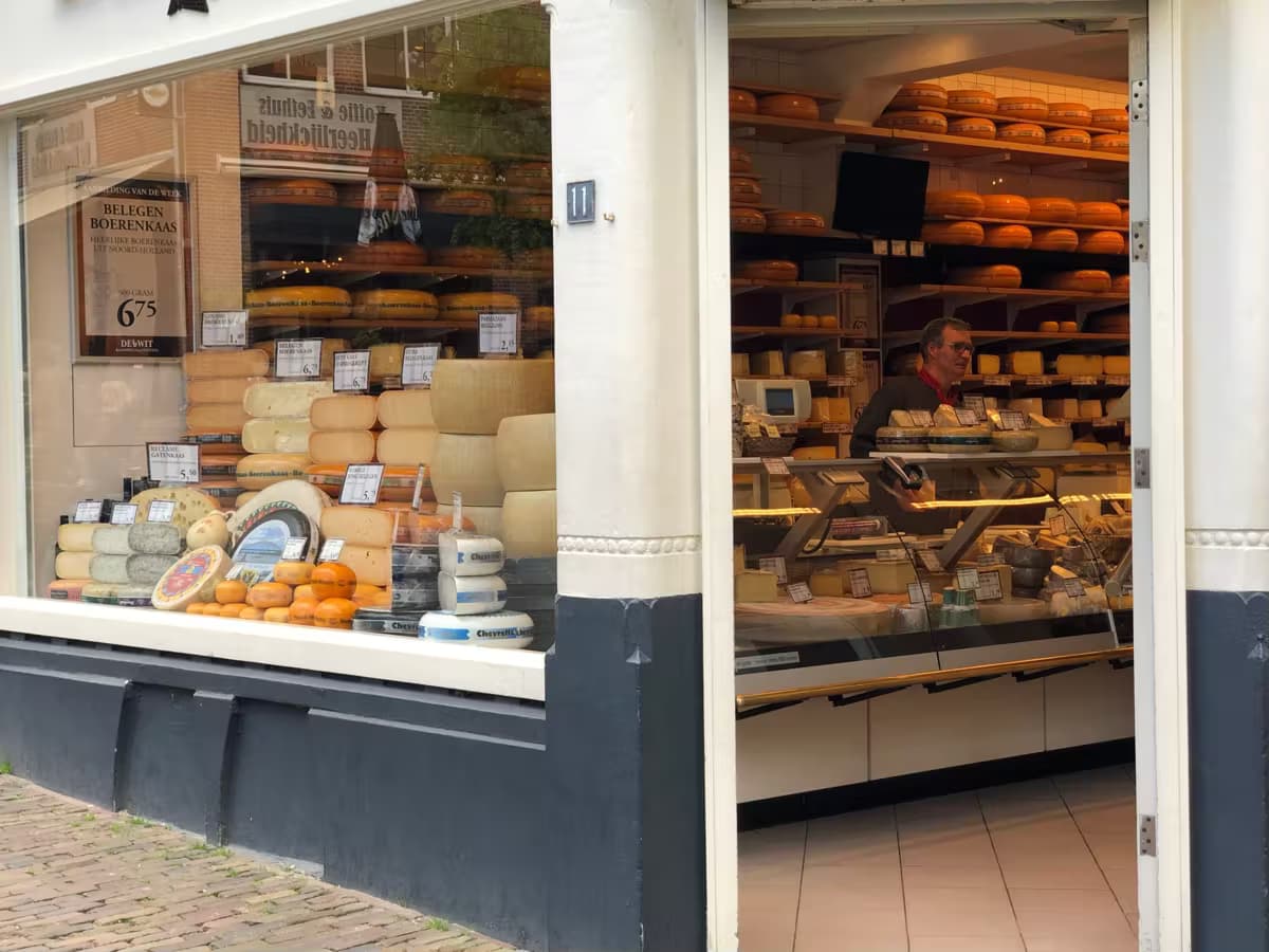 Cheese shop with a fully stocked window display and counter